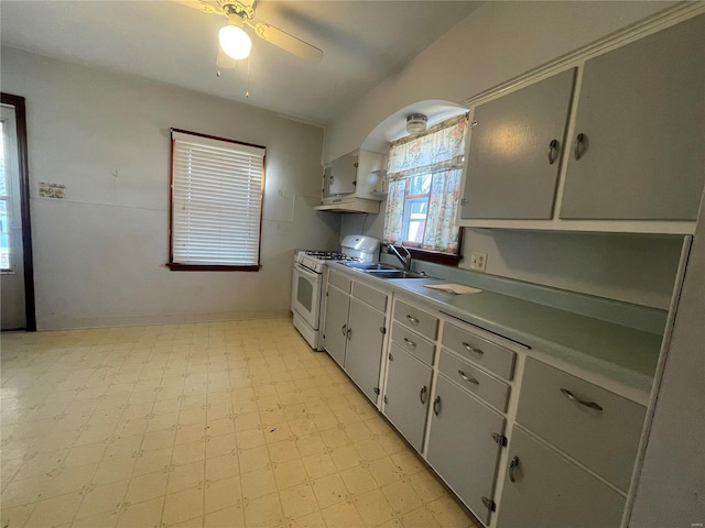 kitchen featuring ceiling fan, sink, and white gas range oven