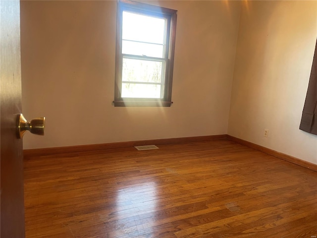 unfurnished room featuring hardwood / wood-style floors