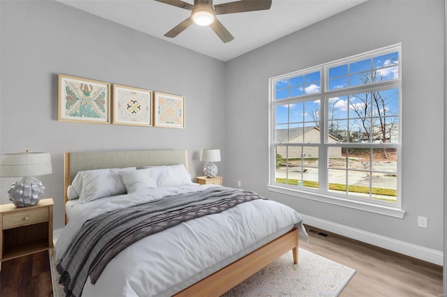 bedroom with wood-type flooring and ceiling fan