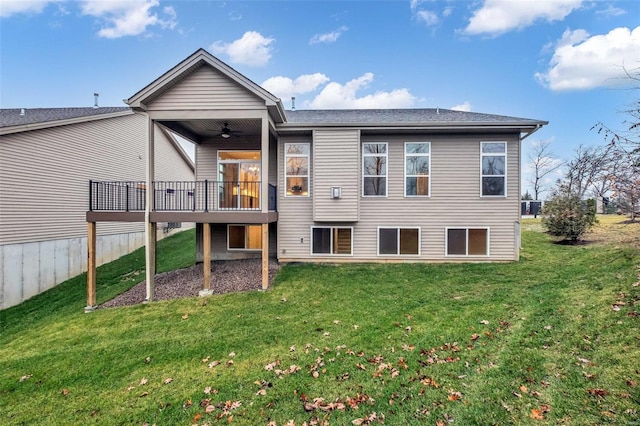 rear view of property with a lawn, ceiling fan, and a deck