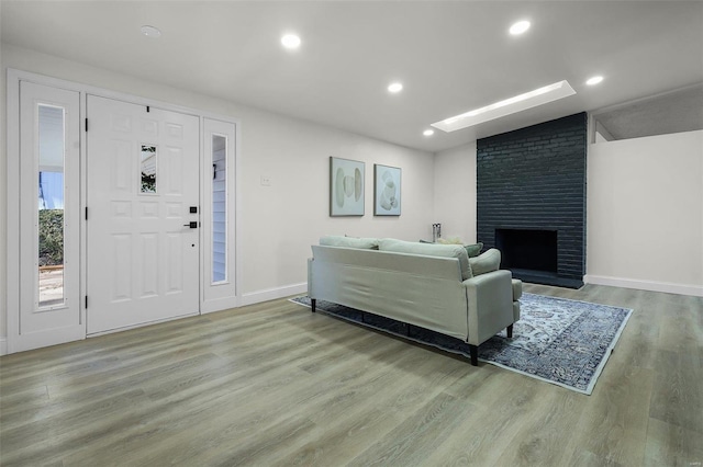 living room with a fireplace and light hardwood / wood-style flooring