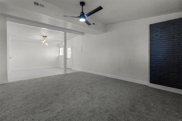 empty room with a textured ceiling, carpet floors, and ceiling fan