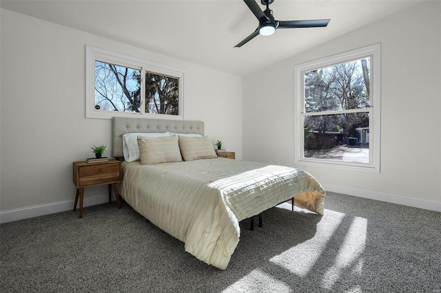 carpeted bedroom featuring vaulted ceiling, multiple windows, and ceiling fan