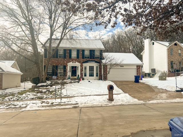 colonial home with a garage