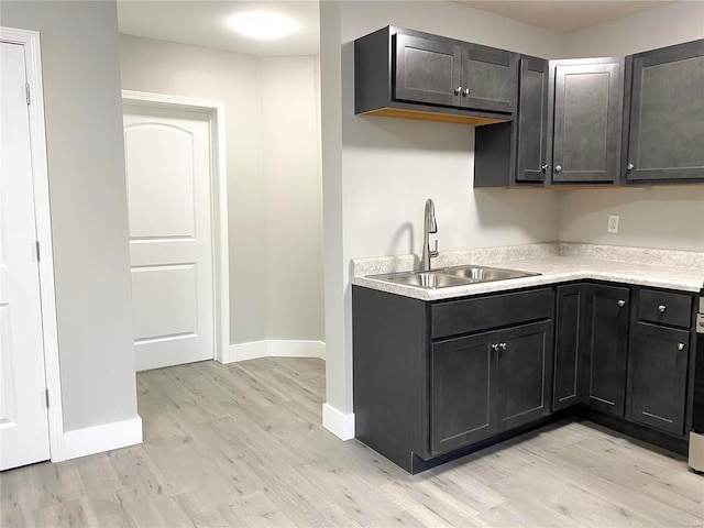 kitchen with sink and light hardwood / wood-style flooring