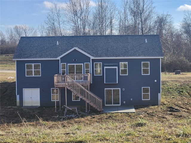 back of house with a wooden deck and a patio