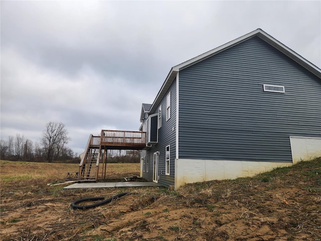 view of side of property with a wooden deck