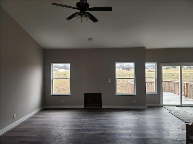 spare room featuring ceiling fan and dark wood-type flooring