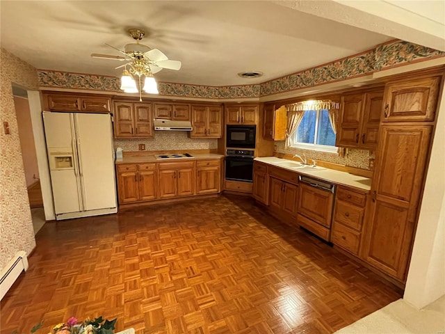 kitchen featuring dark parquet flooring, ceiling fan, sink, a baseboard heating unit, and black appliances