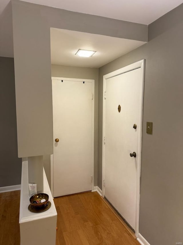 corridor with light hardwood / wood-style floors