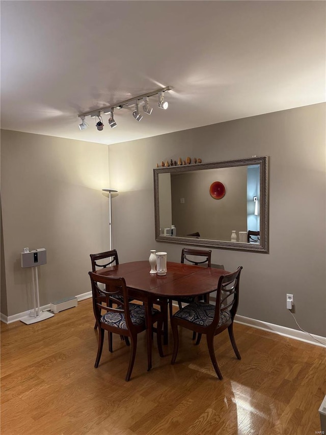 dining space with light hardwood / wood-style flooring