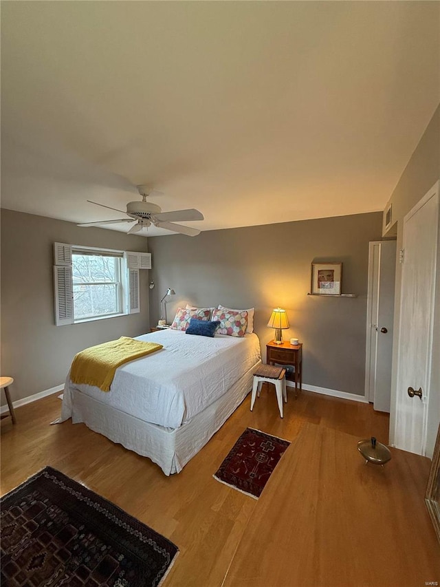 bedroom with ceiling fan and hardwood / wood-style floors