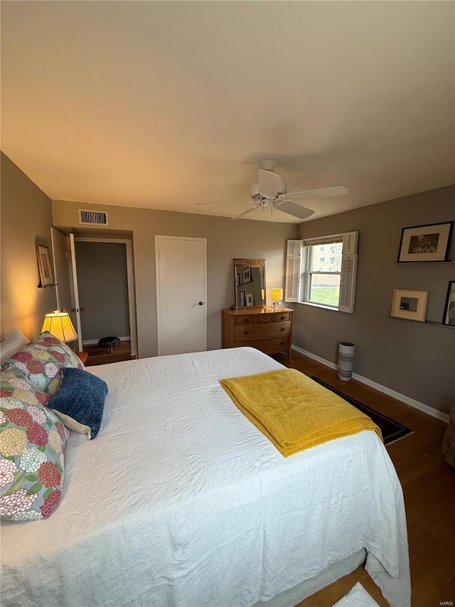 bedroom with ceiling fan and dark wood-type flooring