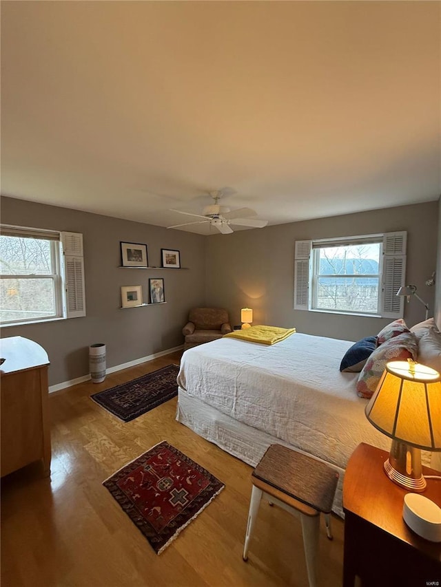 bedroom with ceiling fan and wood-type flooring