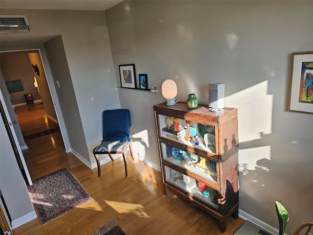 living area with hardwood / wood-style floors