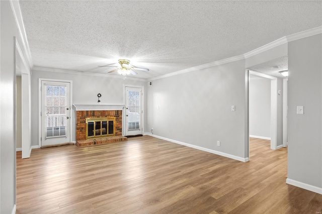 unfurnished living room with a fireplace, a textured ceiling, and ornamental molding