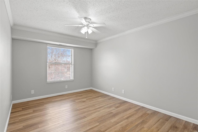 empty room featuring ceiling fan, crown molding, light wood-type flooring, and a textured ceiling