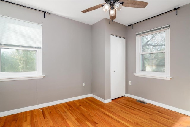 unfurnished room with ceiling fan and light hardwood / wood-style floors