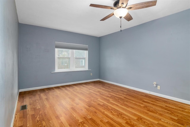 spare room with ceiling fan and light hardwood / wood-style flooring