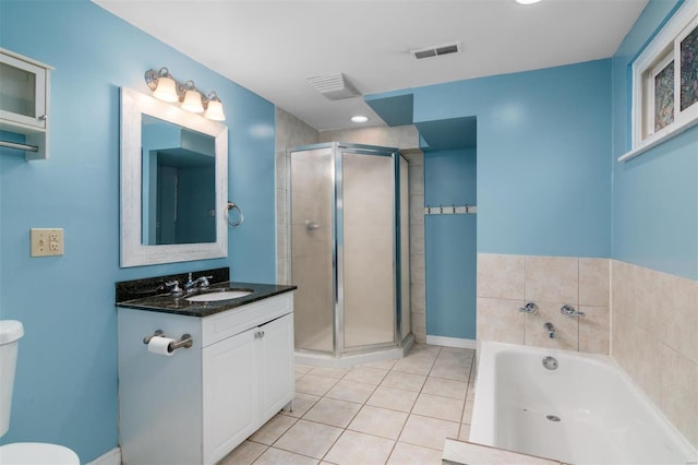 full bathroom with tile patterned flooring, vanity, toilet, and independent shower and bath