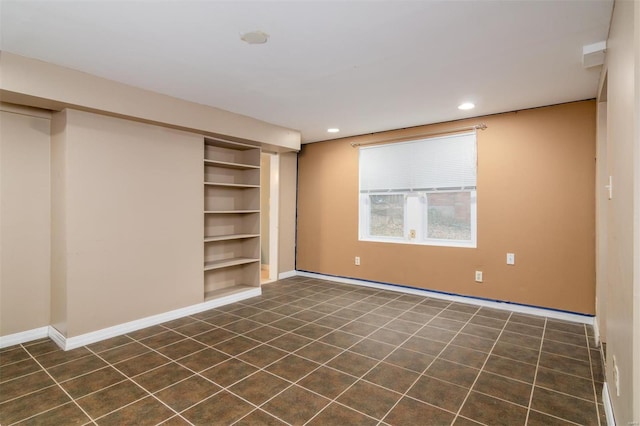 interior space featuring a closet and dark tile patterned flooring