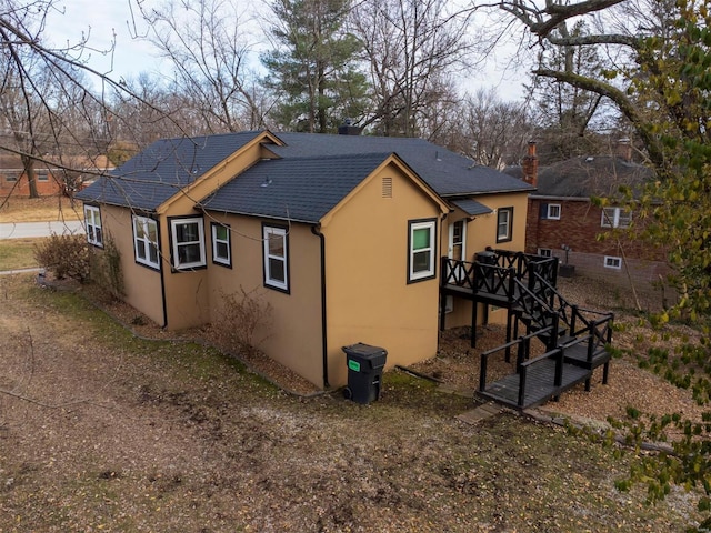 back of property with a wooden deck