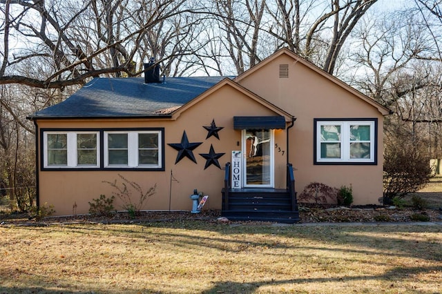 bungalow-style house with a front yard