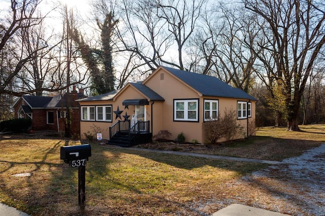 bungalow-style house with a front lawn