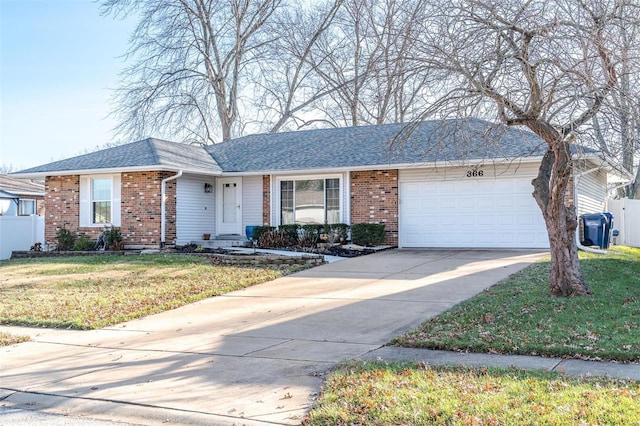 single story home with a front yard and a garage