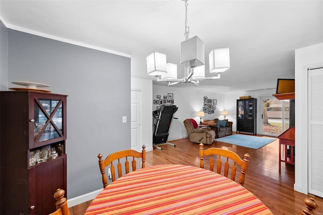 dining area featuring wood-type flooring and an inviting chandelier