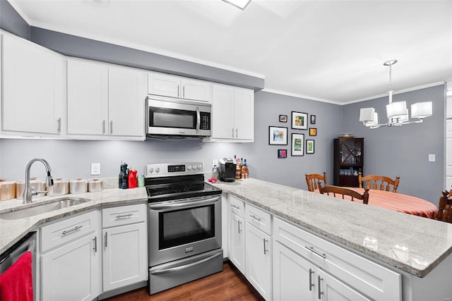 kitchen with kitchen peninsula, stainless steel appliances, sink, an inviting chandelier, and white cabinets