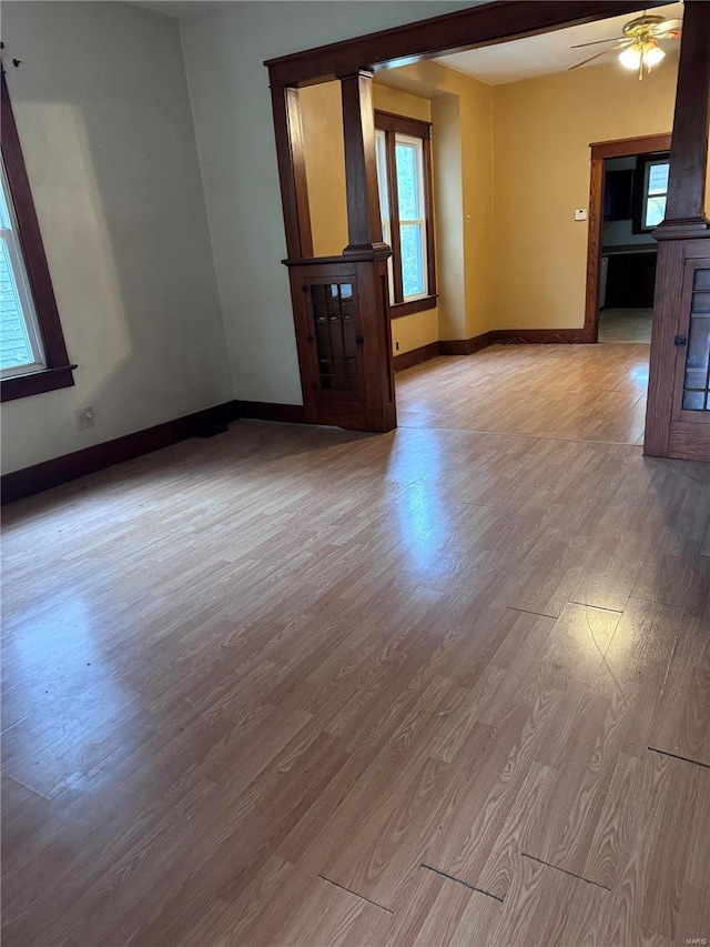 empty room with ceiling fan and light wood-type flooring