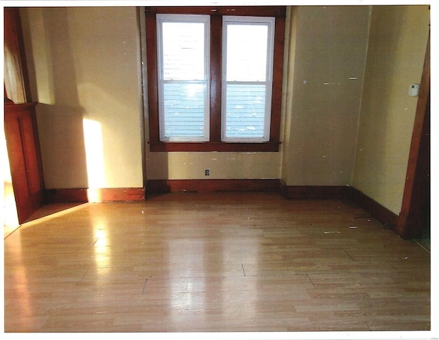 spare room with wood-type flooring