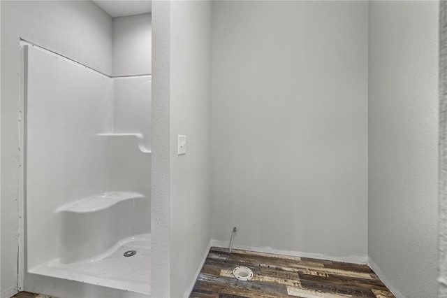 bathroom featuring a shower and hardwood / wood-style floors