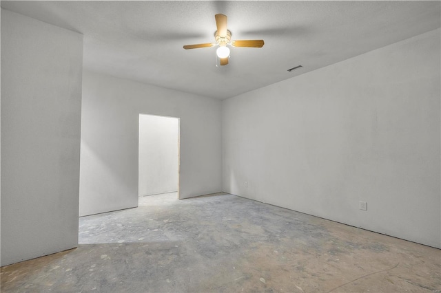 unfurnished room featuring ceiling fan and a textured ceiling