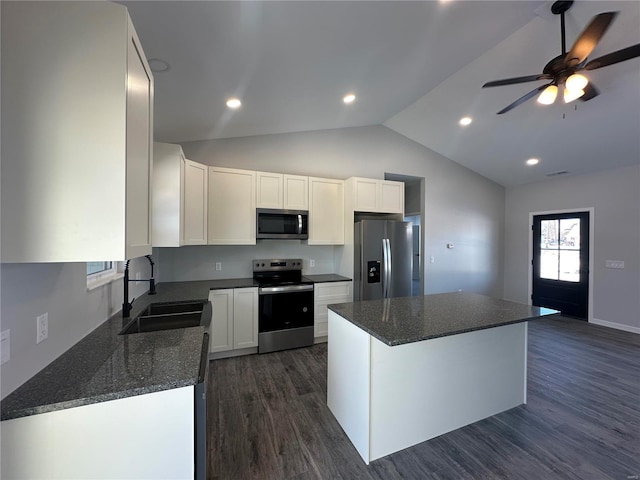 kitchen with white cabinetry, sink, stainless steel appliances, and a kitchen island