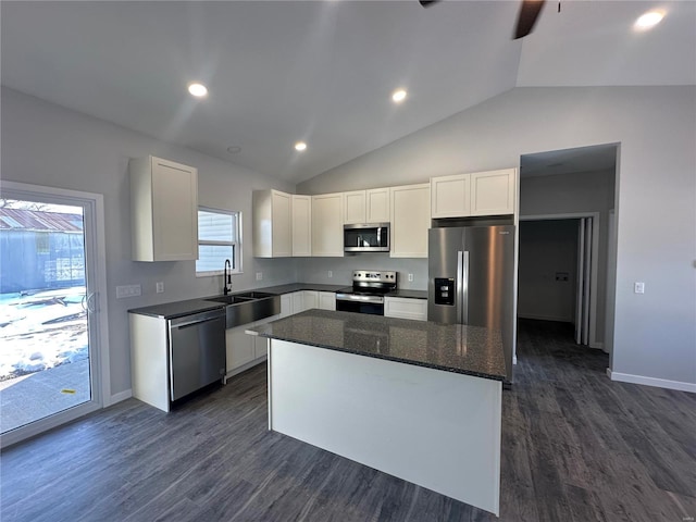 kitchen with white cabinetry, sink, a kitchen island, and appliances with stainless steel finishes