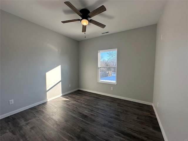 empty room with dark wood-type flooring and ceiling fan