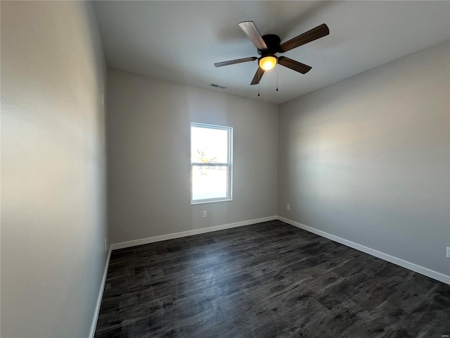 unfurnished room with ceiling fan and dark hardwood / wood-style flooring