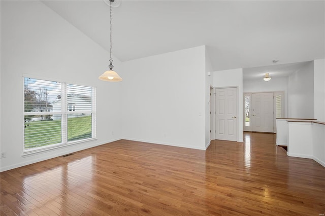 interior space with high vaulted ceiling and hardwood / wood-style flooring