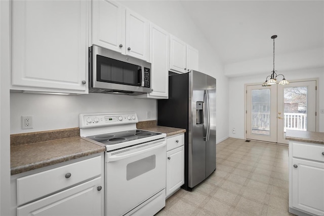 kitchen with french doors, white cabinets, stainless steel appliances, and vaulted ceiling