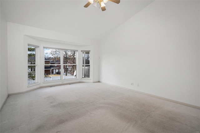 carpeted empty room featuring ceiling fan and lofted ceiling