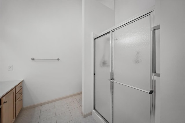 bathroom featuring vanity, tile patterned floors, and an enclosed shower