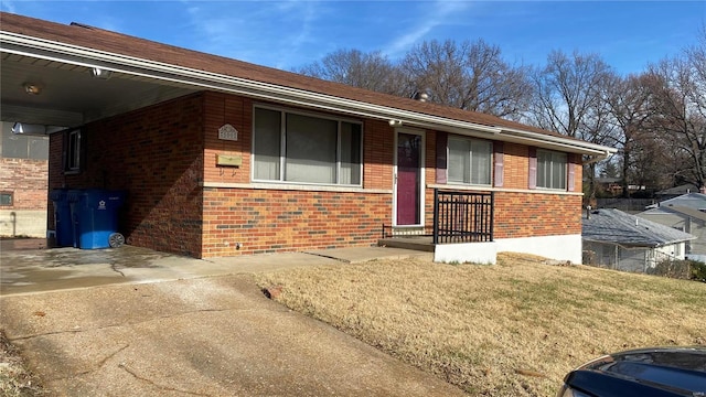 ranch-style house with a front lawn and a carport