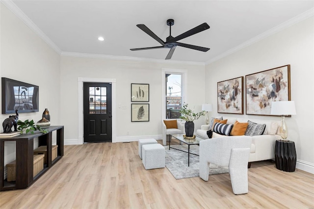 living room with a wealth of natural light, crown molding, ceiling fan, and light wood-type flooring