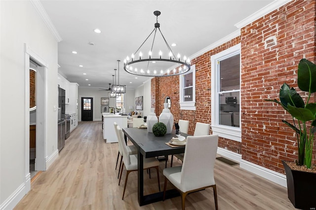 dining room with ornamental molding, brick wall, and light hardwood / wood-style flooring