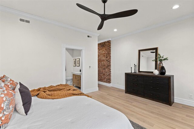 bedroom featuring connected bathroom, light hardwood / wood-style flooring, ceiling fan, and crown molding