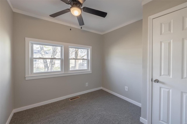 spare room with carpet flooring, ceiling fan, and crown molding