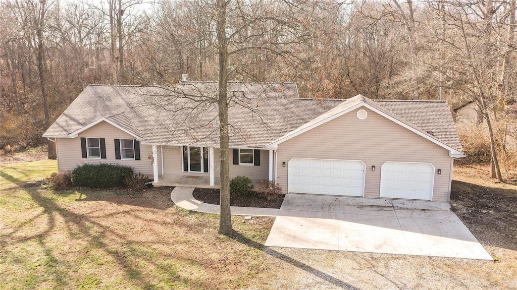 single story home featuring a garage and a front yard