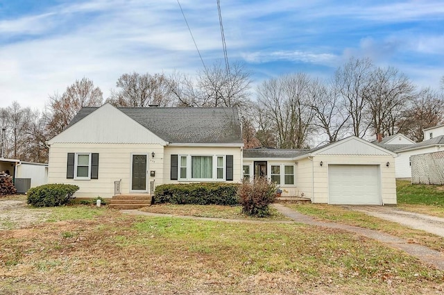 single story home featuring a garage and a front yard